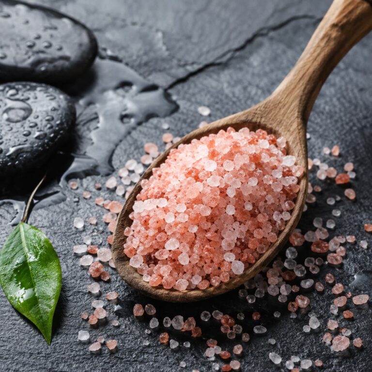 Coarse unrefined sea salt minerals in a wooden spoon illustrating mineral balance